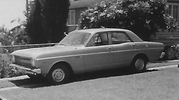 A black and white image of an old car