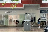 Men lining outside a barbershop in Newcastle.