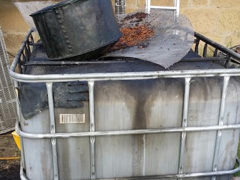 The 1000 litre container holding the used chip oil to run the distillery.