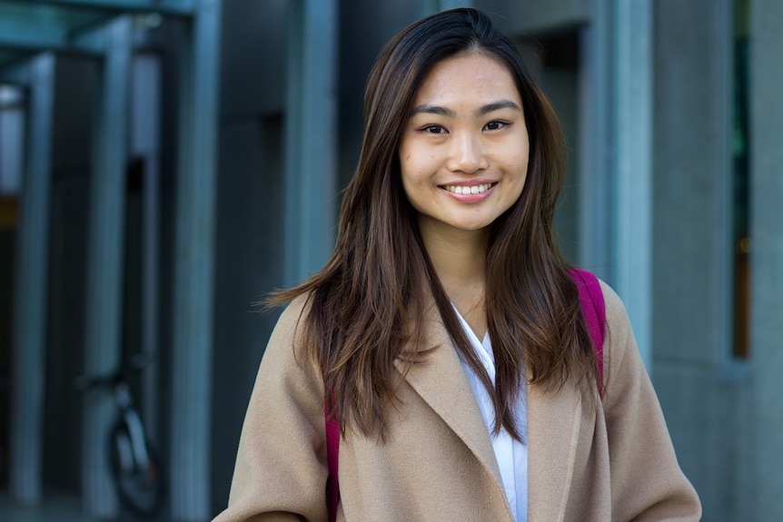 Medical student Angell Zang wearing winter jacket and backpack.