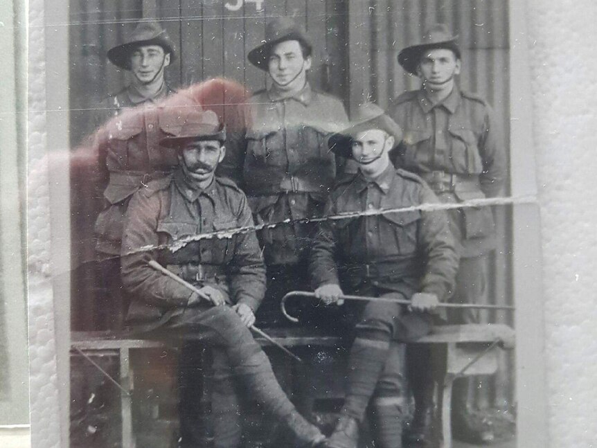 Black and white photo of Harold Prosser (back left) standing in uniform with four other soldiers.