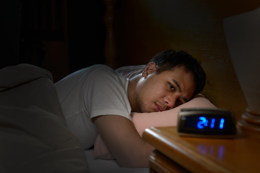 Man with insomnia lying on the bed