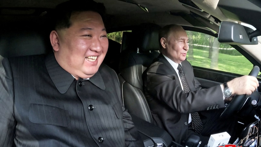 The two leaders are smiling like kids while Putin is driving.