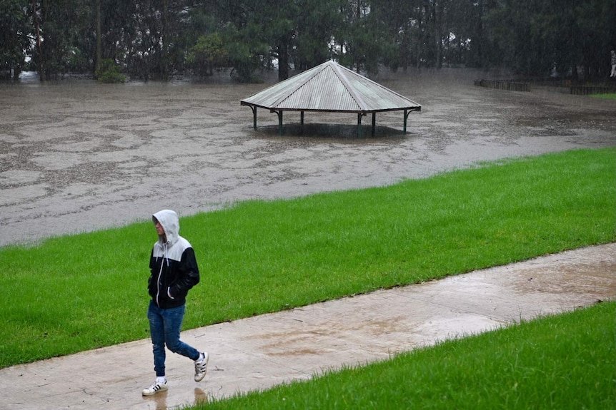 A man walks near a rotunda roof underwater