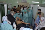 Hospital workers attend to the injured after an alleged chemical attack.