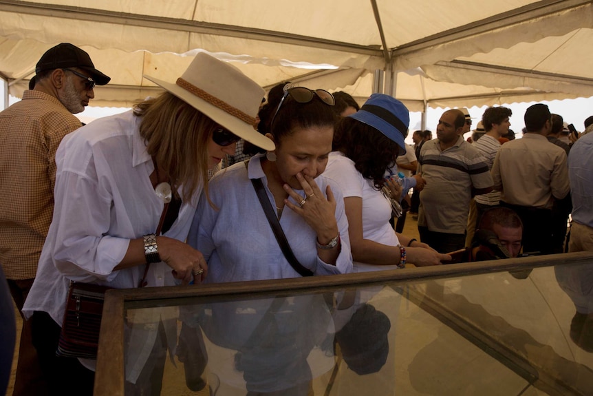 Women look at recently discovered artefacts at the Bent Pyramid
