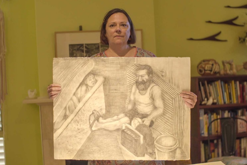 Woman holding a sketch of a bearded man sitting on the floor with little girl peeking out from under a mattress over a bath.