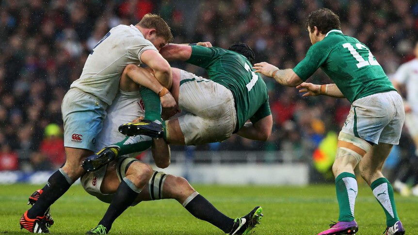 Ireland's Sean O'Brien is tackled by England's Tom Youngs and Chris Robshaw at Landsdowne Road.