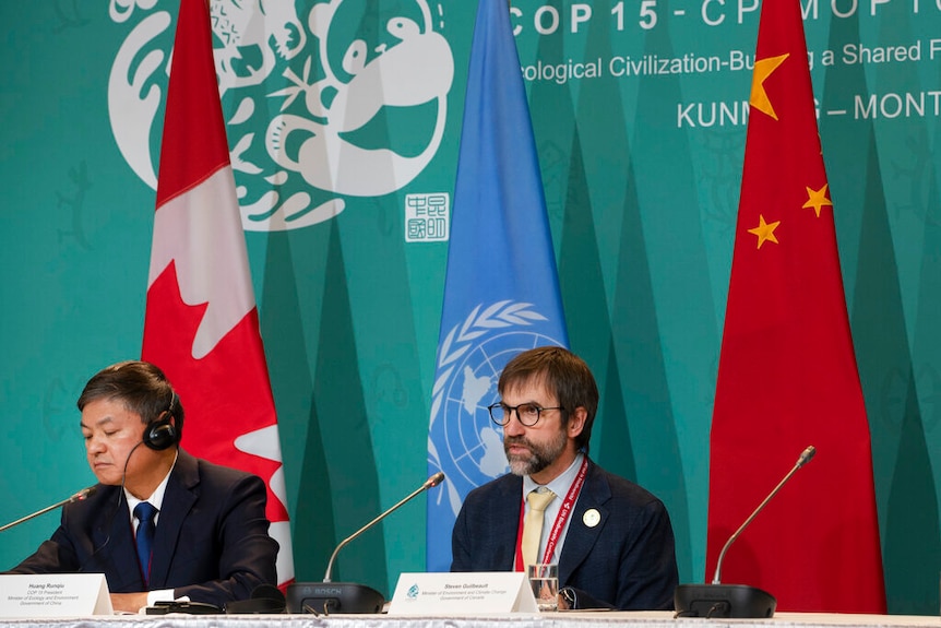 Huang Runqiu, left, President of the COP 15 and Minister of Ecology and Environment of China 