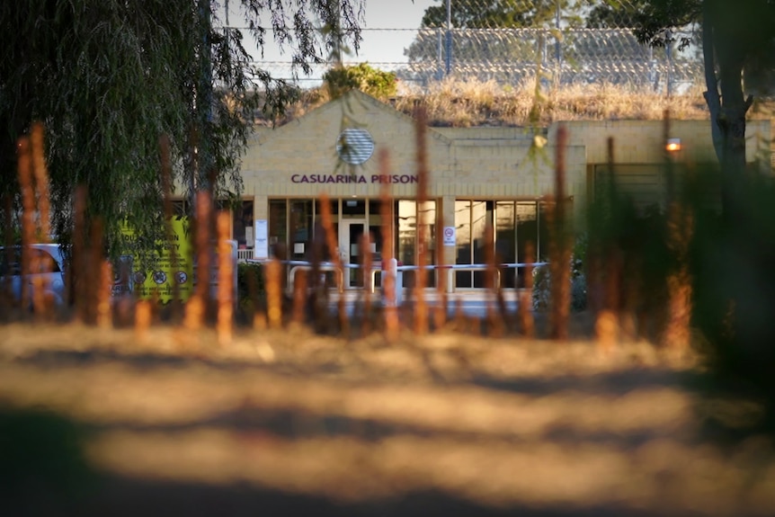 The front façade of a prison at dusk