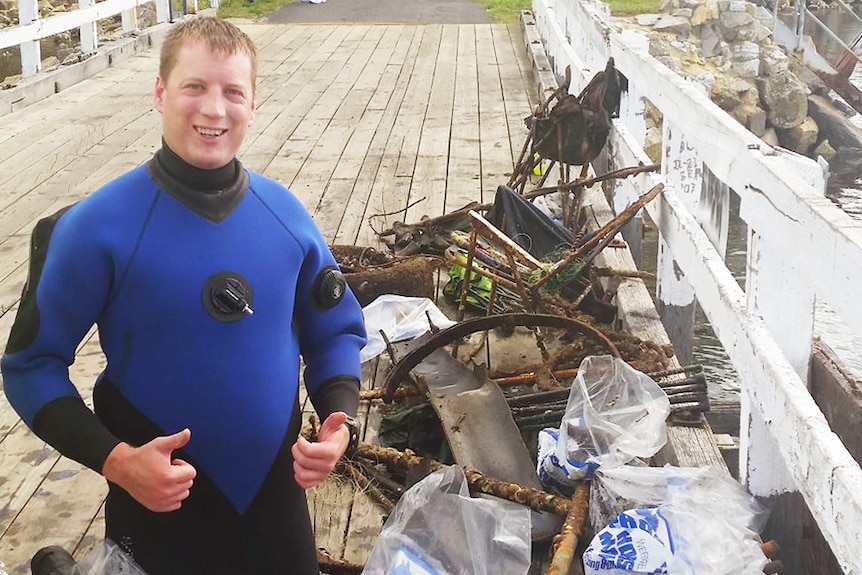 Andrew Bain with items retrieved from River Derwent.