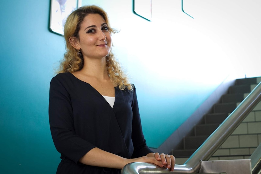 Nada Hassoun stands on a staircase at the Tropical North Queensland TAFE Cairns campus.