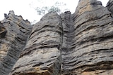 sandstone rock face with crack down middle