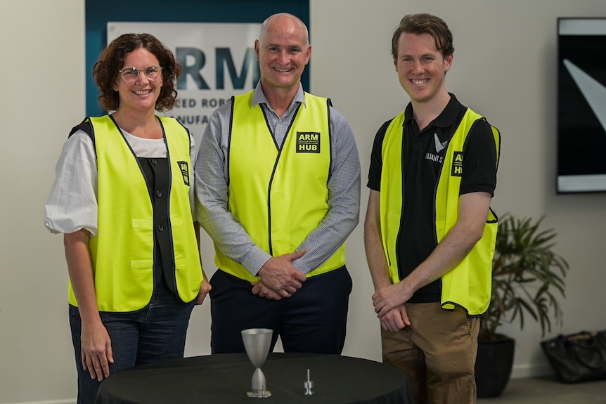 Three people in high-vis vests