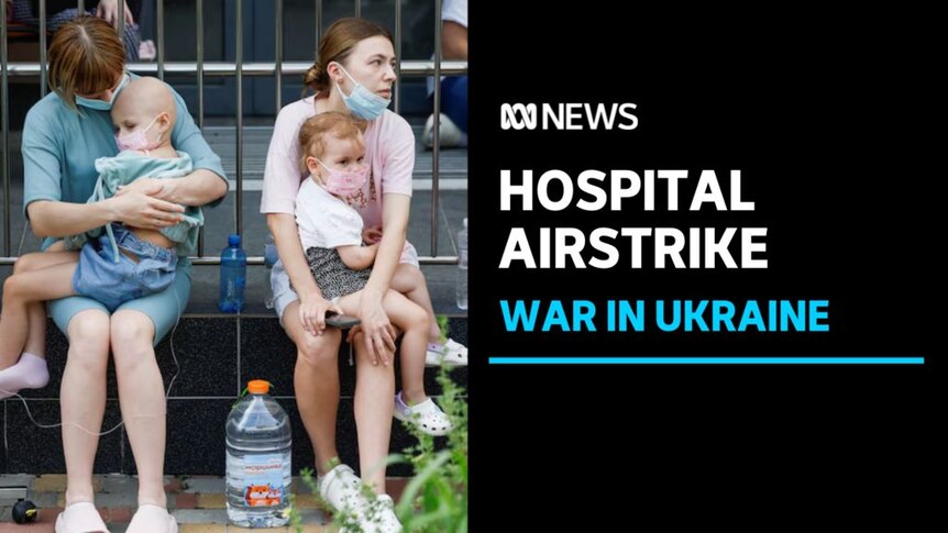 Hospital Airstrike, War in Ukraine: Two women sit on a low wall, each with a small child on their laps.