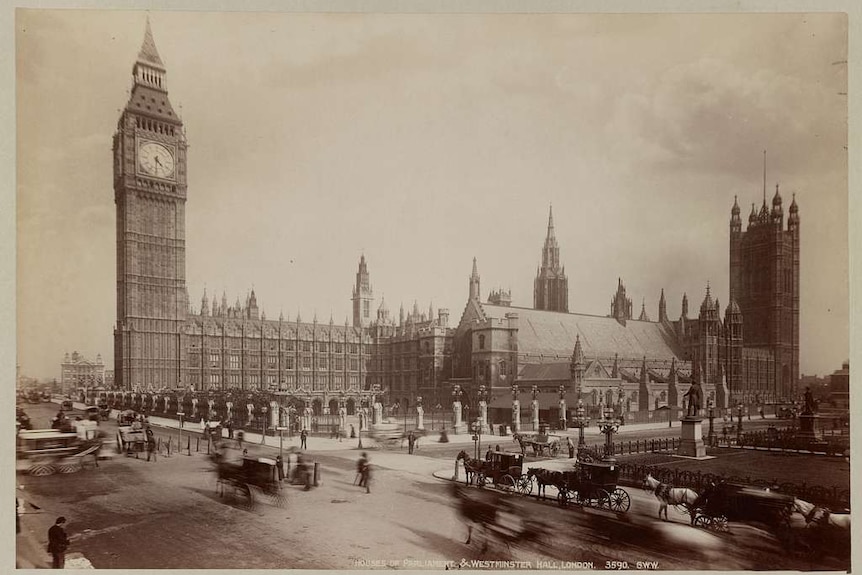 Passing horse and carriages in front of The Palace of Westminster and Big Ben in 1880.