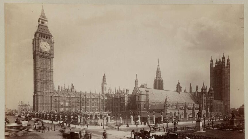 Passing horse and carriages in front of The Palace of Westminster and Big Ben in 1880.