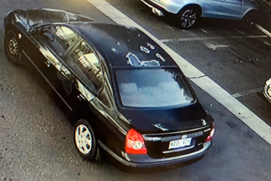 A black sedan in a car park