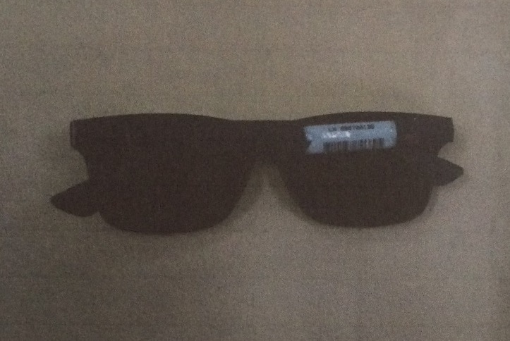Black and white photo of a pair of men's sunglasses