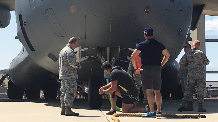 Grant Edwards kneels before the C-17.