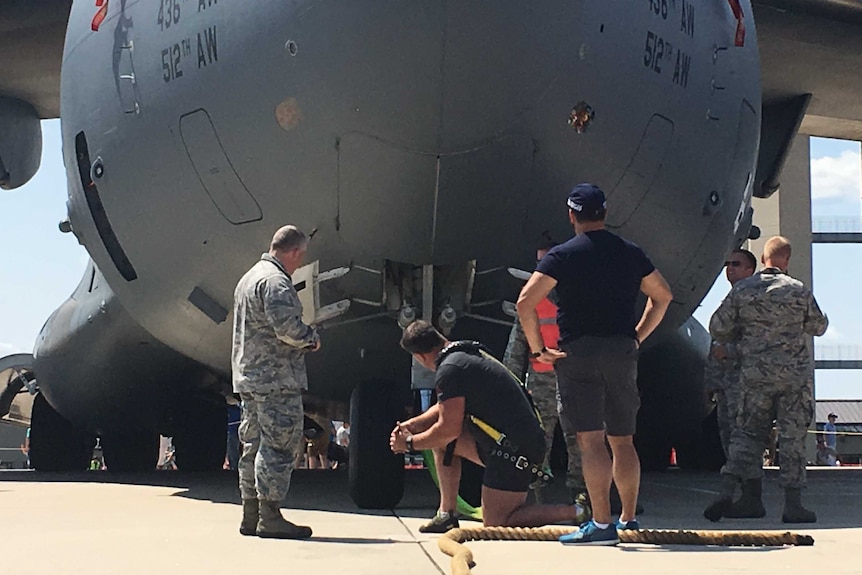Grant Edwards kneels before the C-17.