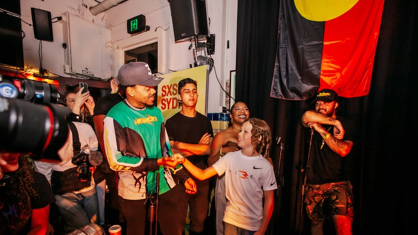 11-year-old rapper Inkabee grins up at superstar Chance The Rapper at The Lord Gladstone pub in Sydney.