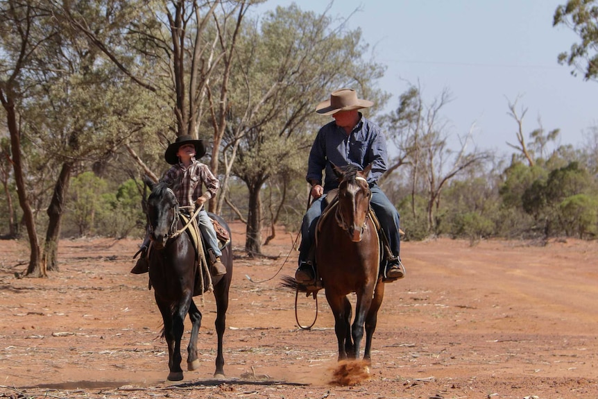 Bill Prow and his son Cody riding horses together on the property