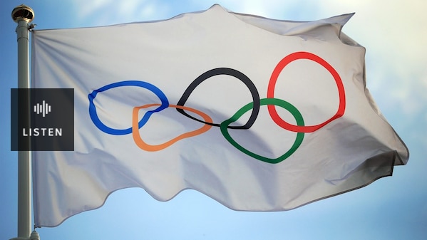 A white flag with the Olympic Games rings on it. Has Audio.
