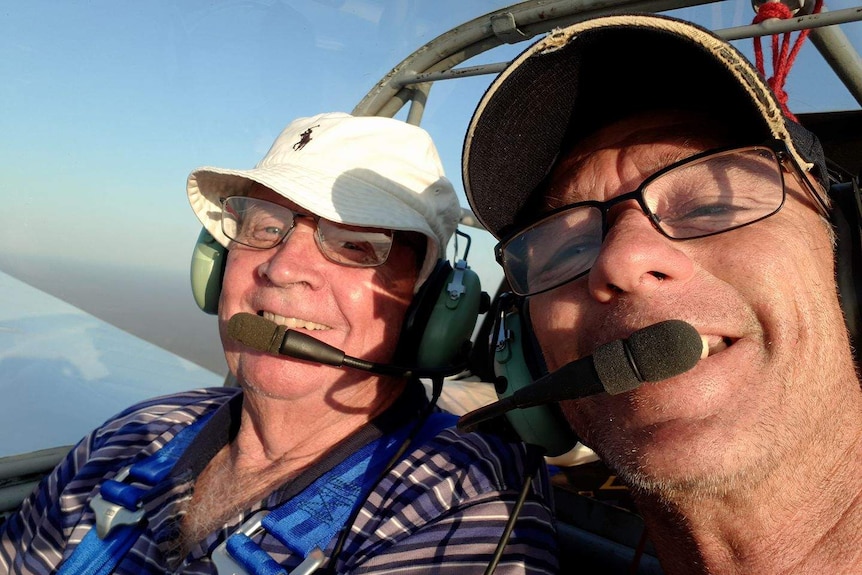 Gliders Graeme Clinton and Greg McDonald in the air with headsets on.