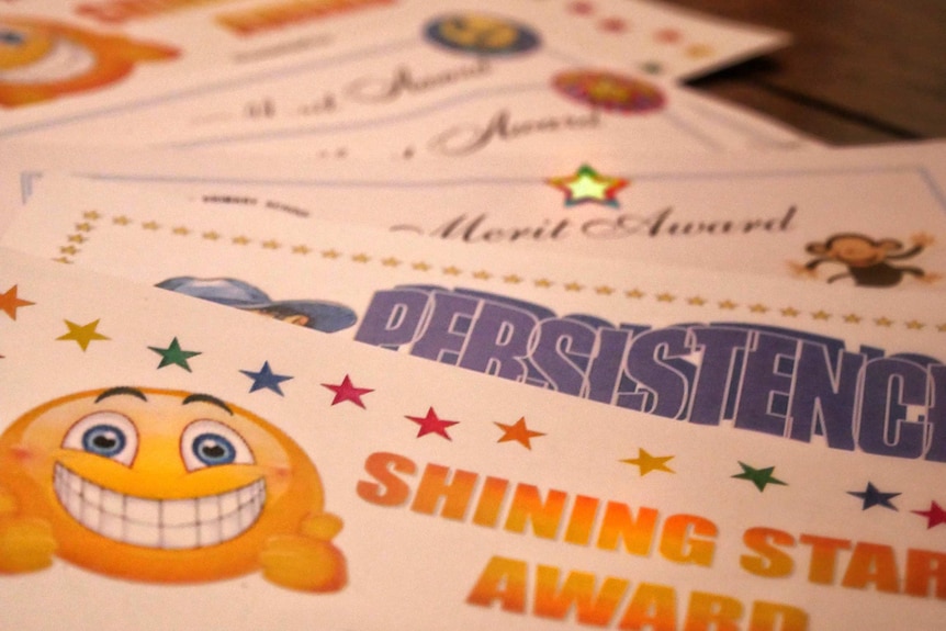 A close up of several merit award certificates