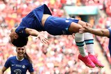 Sam kerr is mid-backflip with Chelsea teammates around her after a goal in the Women's FA Cup final.