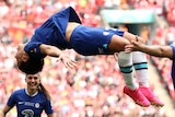 Sam kerr is mid-backflip with Chelsea teammates around her after a goal in the Women's FA Cup final.
