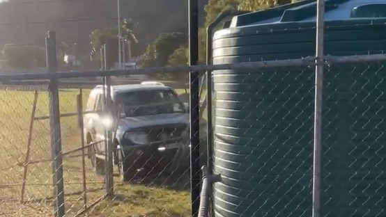 A large four wheel drive rams a fence on an oval