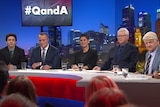 Six people seated in front of an audience on QandA.