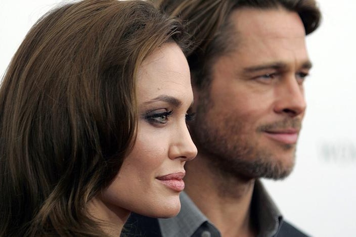 A close up photograph of Angelina Jolie and Brad Pitt posing together