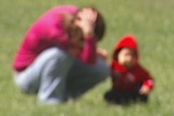 Video still: Blurred image of woman and child