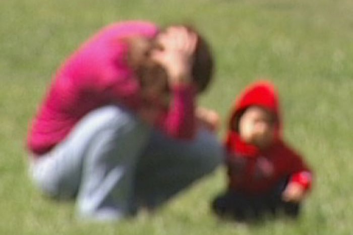 Video still: Blurred image of woman and child