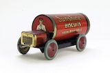 An old red and gold Sunshine biscuits tin turned into a toy car