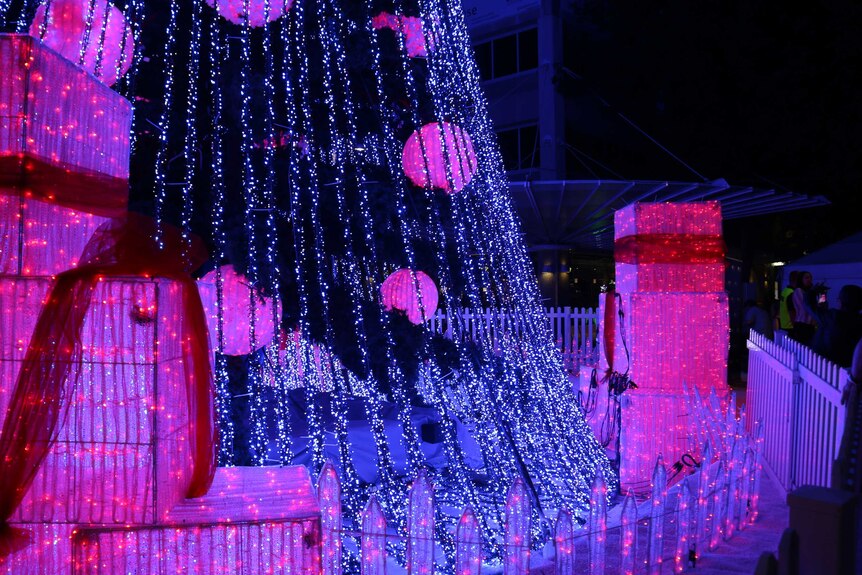 Illuminated presents at the base of the Christmas tree.