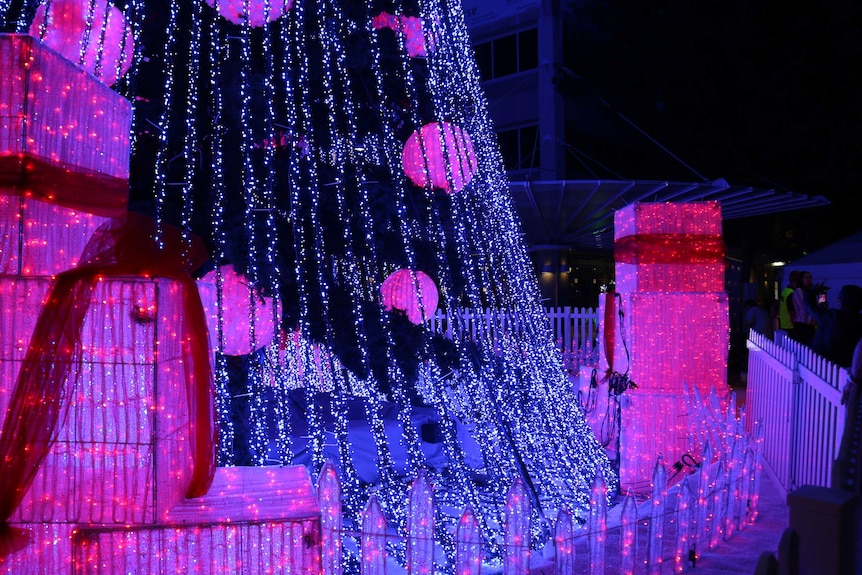 Illuminated presents at the base of the Christmas tree.