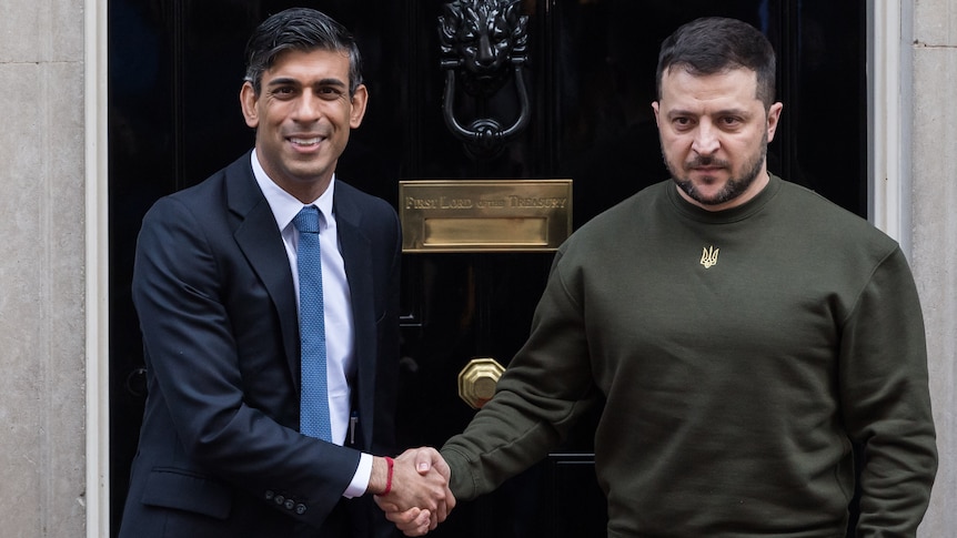 UK Prime Minister RIshi Sunak, wearing a suit, shakes the hand of Ukrainian President Volodymyr Zelenskyy, outside 10 Downing St