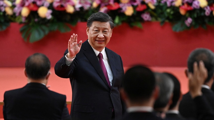 A man waving to cameras