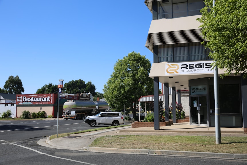 A commercial office building on the corner of a street, with the words "Regis Resources" visible