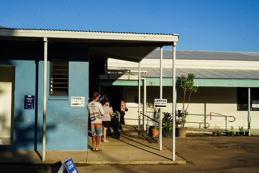 An exterior image of a voting centre in Parap, a suburb of Darwin, showing people waiting in line