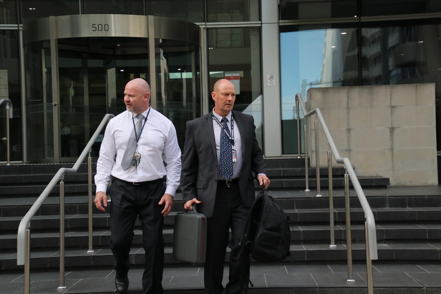 The two men walk out of the court.