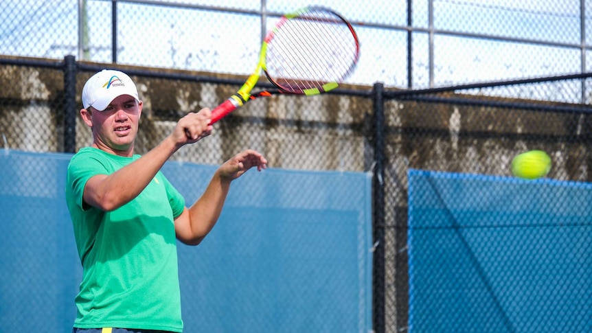 Man playing tennis.