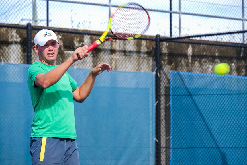 Man playing tennis.