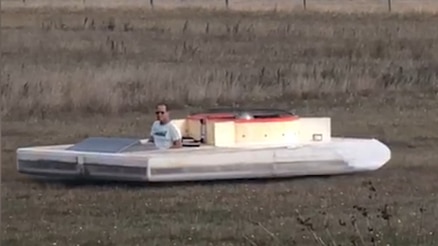 peter in his white hovercraft creation on a field 