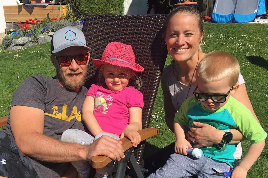 Hamish and Bettina Rowley sit outside with children Charlotte and Freddie.