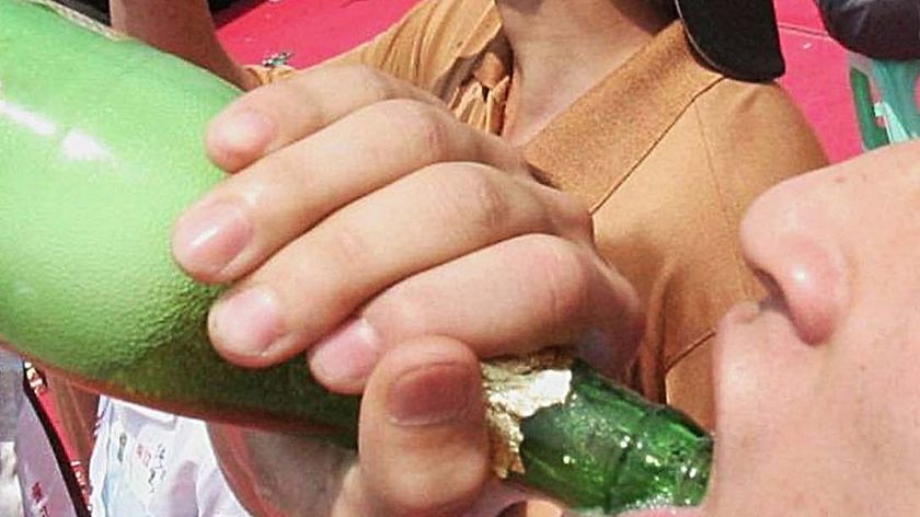 A youth takes part in a beer drinking competition